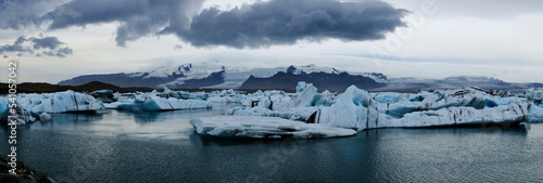Blocks of ice in the Jökulsárlón glacier lagoon in Iceland. Panoramic shot of the lagoon with the glacier in the background.