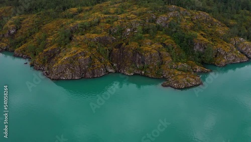 Lake bottom Loenvatnet with glacial river starting to flow dowm Lodalen valley. moving aerial photo