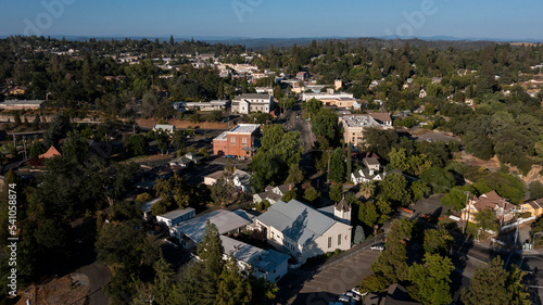 Light shines on historic structures in downtown Auburn, California, USA.