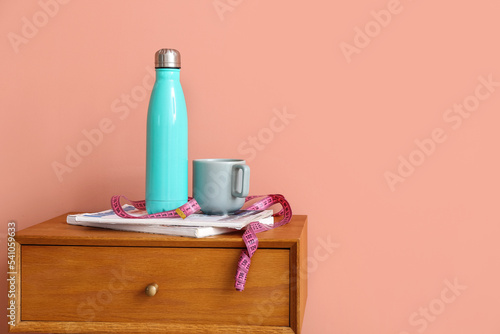 Bottle of water, cup, measu...