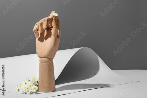 Wooden hand with flowers on...