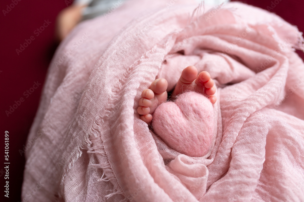 legs of a newborn baby. heart at the feet legs of a newborn baby. heart at the feet