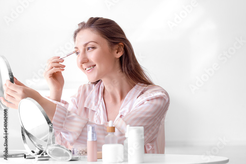 Young woman with mirror and...
