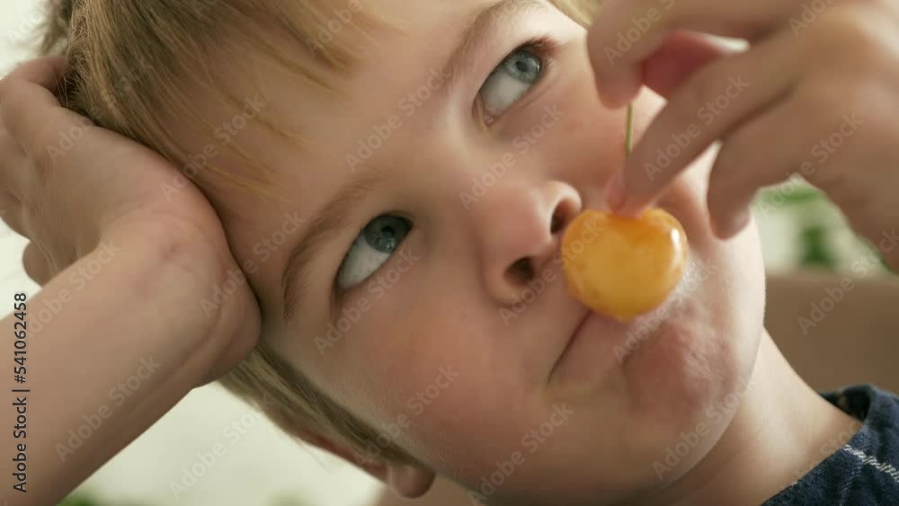 Close-up Cute Little Boy Kid Child Enjoy Eat Sweet Cherry Fruit Food Meal Kitchen Home Day Dining Room. 2x Slow motion 60 fps 4K Close-up Cute Little Boy Kid Child Enjoy Eat Sweet Cherry Fruit Food Meal Kitchen Home Day Dining Room. 2x Slow motion 60 fps 4K