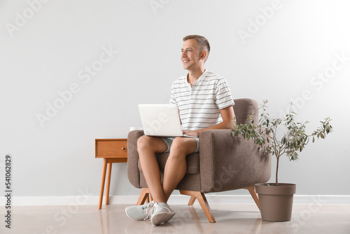 Young man using laptop in s...