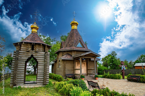 A Christian temple made of a wooden frame with a golden dome and a cross. Orthodox Church of Ukraine. Christian Cathedral. A place for prayer of believers. Religion and culture.
