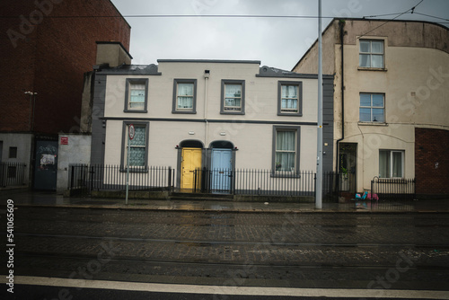 Blue and yellow door on a house in Dublin, Ireland with traditional Irish weather. © Tomas Bazant