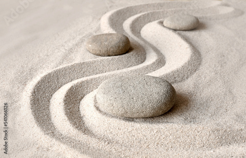 Zen garden meditation stone background with stones and lines in sand for relaxation balance and harmony spirituality or spa wellness