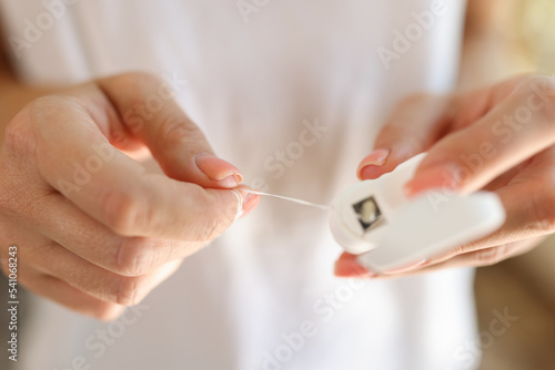 Female hands holding teeth cleaning thread or dental floss