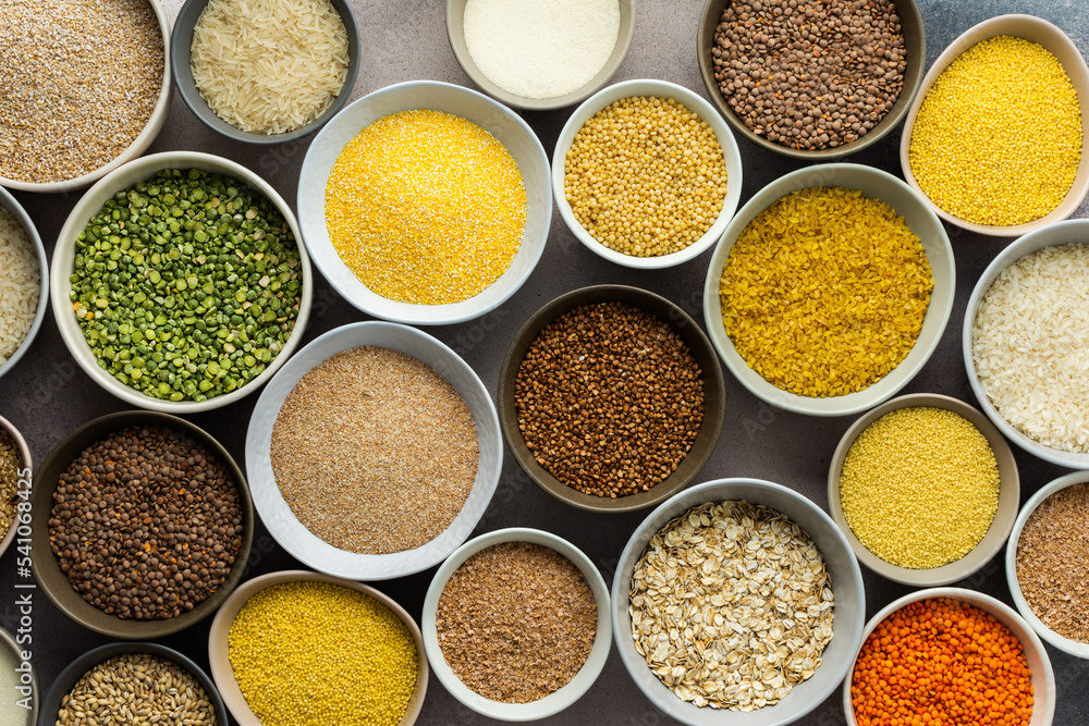 Various grain cereals in bowls on a light background, top view Various grain cereals in bowls on a light background, top view