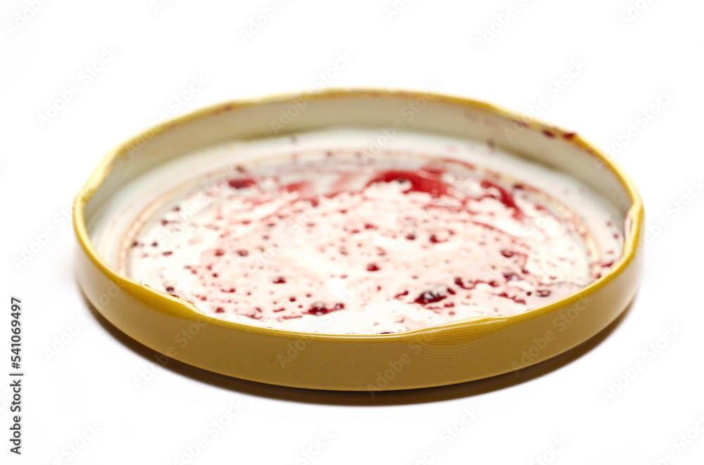 Jar lid with blueberry jam, marmalade stains isolated on white Jar lid with blueberry jam, marmalade stains isolated on white
