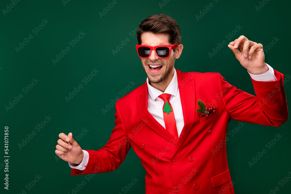 Portrait of positive overjoyed man enjoy festive clubbing good mood isolated on green color background