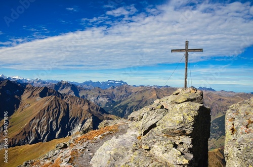 Summit cross on the Hochwart mountain in the Pizol area above the Wildsee and Batoni. Hiking in beautiful autumn. photo