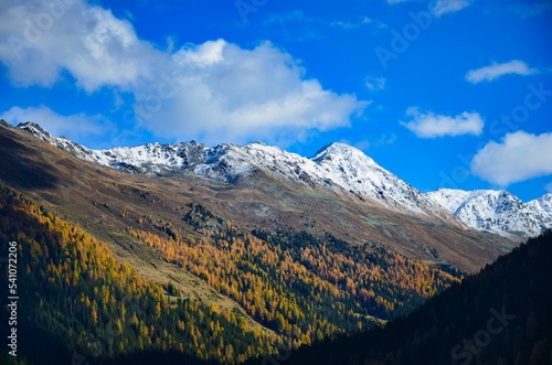Davos mountain landscape in beautiful autumn. Snow on the mountain peaks and larch forests in the valley. Sentisch Horn. High quality photo