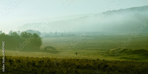 mysterious fog on hillside in autumn Mist, trees are wet, damp fog of forest beautiful landscape Olanesti Moldova Panoramic view rural village Early morning the herd of cows grazing. CINEMATIC
