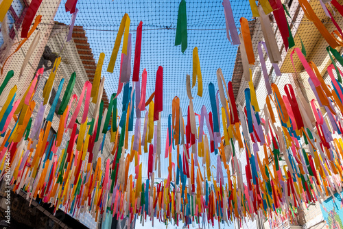Multi-colored textile ribbons hanged in the street of the Old Town of Aveiro.