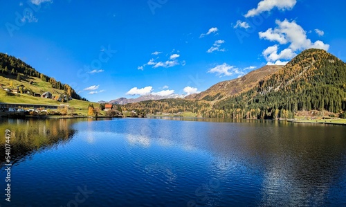 beautiful autumn hike above lake davos. Colored larch forests. Mountain panorama in Davos Klosters Mountains. High quality photo