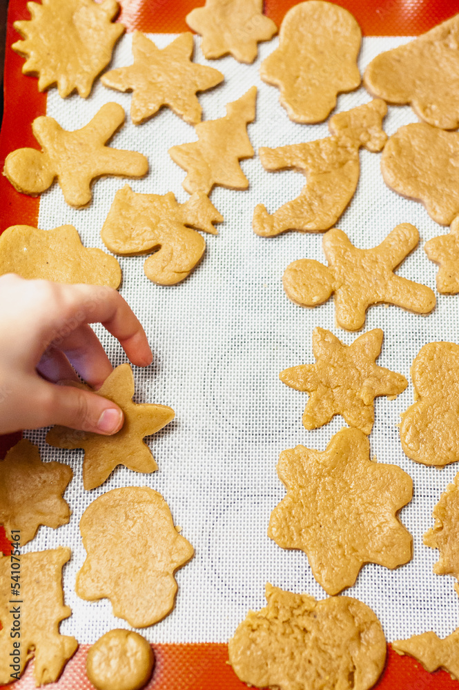 Christmas cookies in the shape of a heart, belea, a star, a tree, a gingerbread man on a baking tray Christmas cookies in the shape of a heart, belea, a star, a tree, a gingerbread man on a baking tray