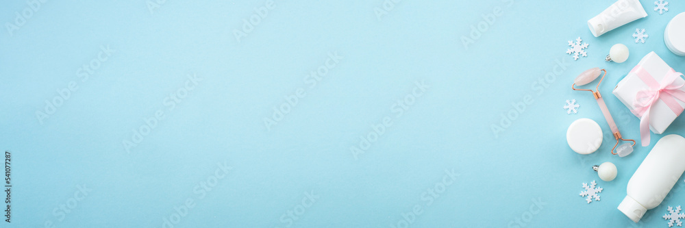 Winter cosmetic, gift and holiday decorations on blue. Winter cosmetic, gift and holiday decorations on blue.