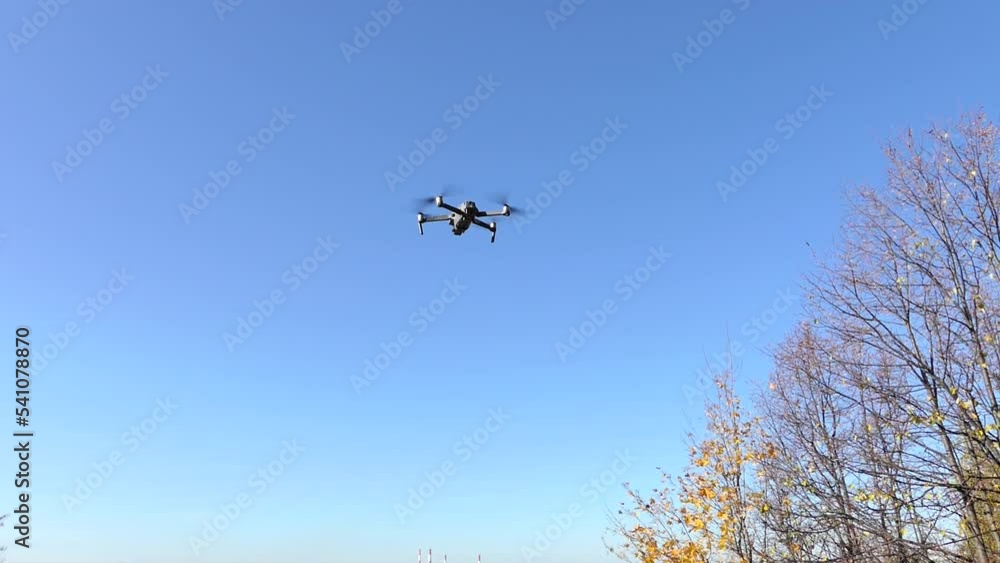 Gray drone in the air against a blue sky. High quality FullHD footage Gray drone in the air against a blue sky. High quality FullHD footage