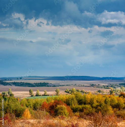 very beautiful autumn landscape of agricultural fields and colorful trees, pa...