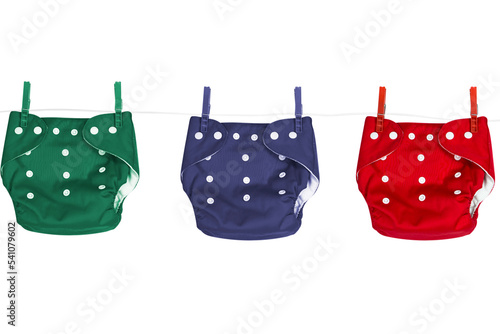Colored ecological cloth diapers hanging on a clothesline photo