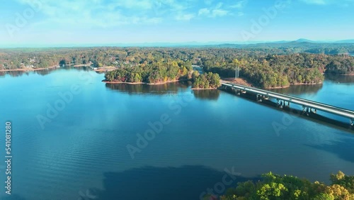 4K Drone footage of Lake Lanier in North Georgia, aerial drone on a sunny fall day. Clear view of fall colored trees and blue lake water.