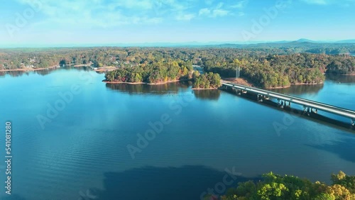 4K Drone footage of Lake Lanier in North Georgia, aerial drone on a sunny fall day. Clear view of fall colored trees and blue lake water. photo