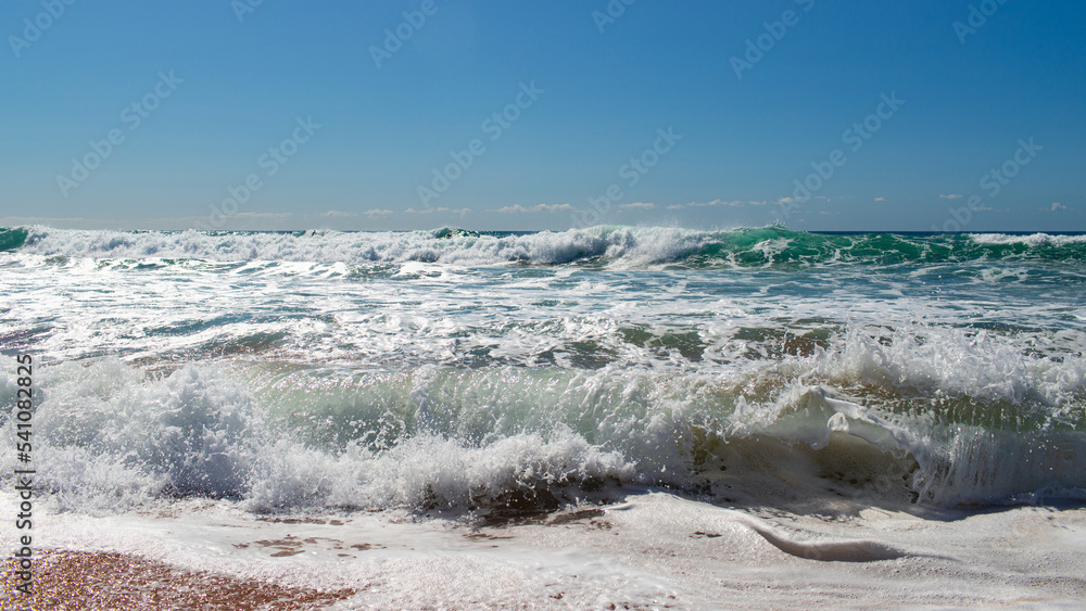 Fototapeta premium Wave breaking on the beach shore.