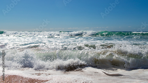 Wave breaking on the beach shore.