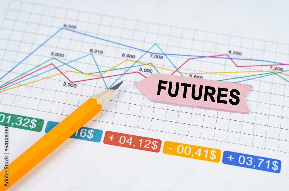 On business charts there is a pencil and an arrow sticker with the inscription - FUTURES On business charts there is a pencil and an arrow sticker with the inscription - FUTURES