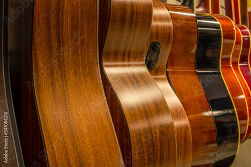Several acoustic guitars in close-up. Musical Instrument Store