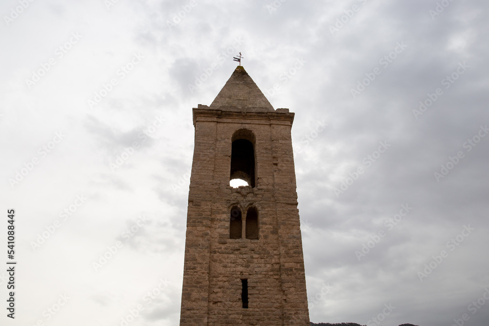 Reservoir with little water in which a church can be seen due to the drought and the little rain effect of global warming