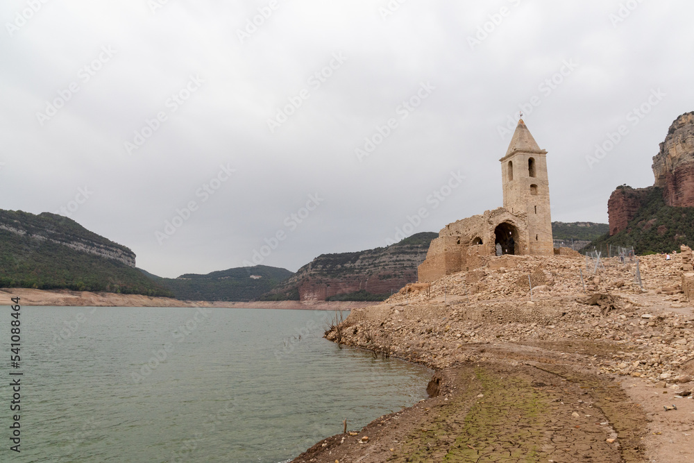 Reservoir with little water in which a church can be seen due to the drought and the little rain effect of global warming