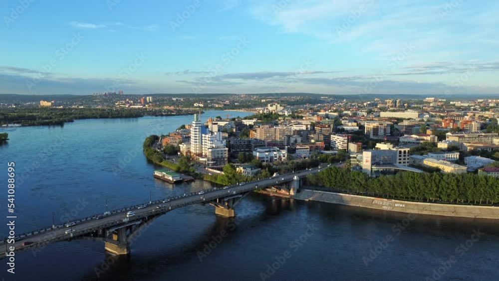 4k Beautiful top view of Irkutsk city on summer day irrl. Aerial pic of cars driving along bridge over blue river in modern town with buildings and infrastructure outdoors. Amazing drone view of 4k Beautiful top view of Irkutsk city on summer day irrl. Aerial pic of cars driving along bridge over blue river in modern town with buildings and infrastructure outdoors. Amazing drone view of