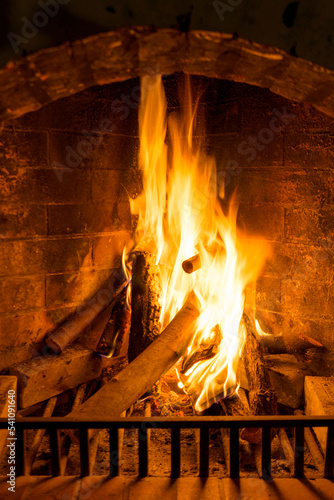 Burning woods in a brick fireplace