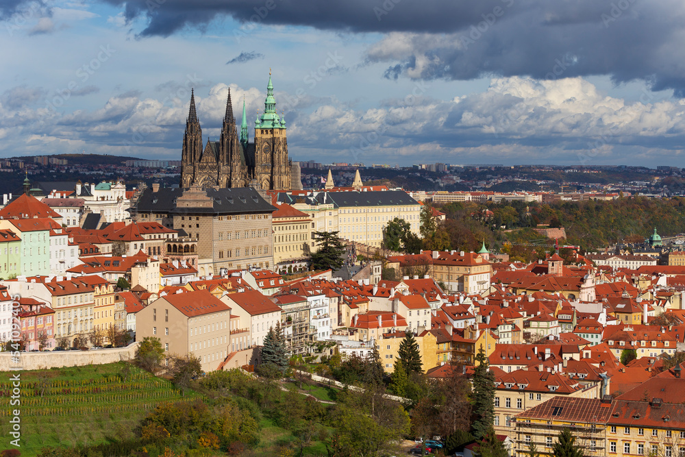 Autumn Prague City with gothic Castle, colorful Nature and Trees and dramatic Sky from the Hill Petrin, Czech Republic