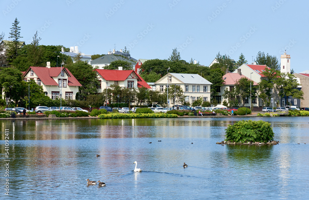 Fototapeta premium Traditional Icelandic houses along the west side of the lake Tjörnin in downtown Reykjavik, Iceland.