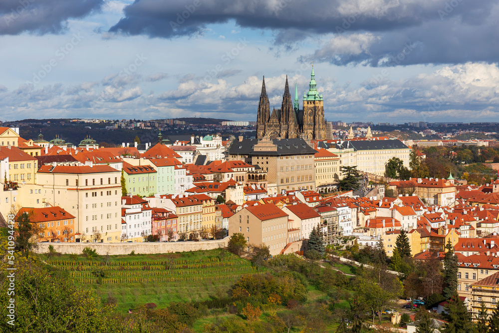 Autumn Prague City with gothic Castle, colorful Nature and Trees and dramatic Sky from the Hill Petrin, Czech Republic