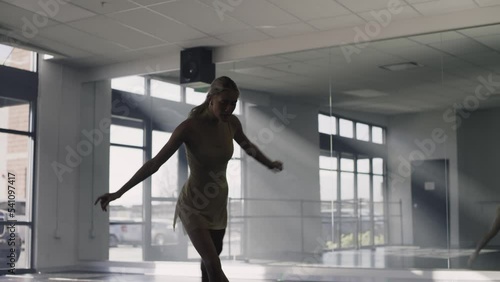 Woman practicing contemporary dancing on floor in dance studio / Lehi, Utah, United States