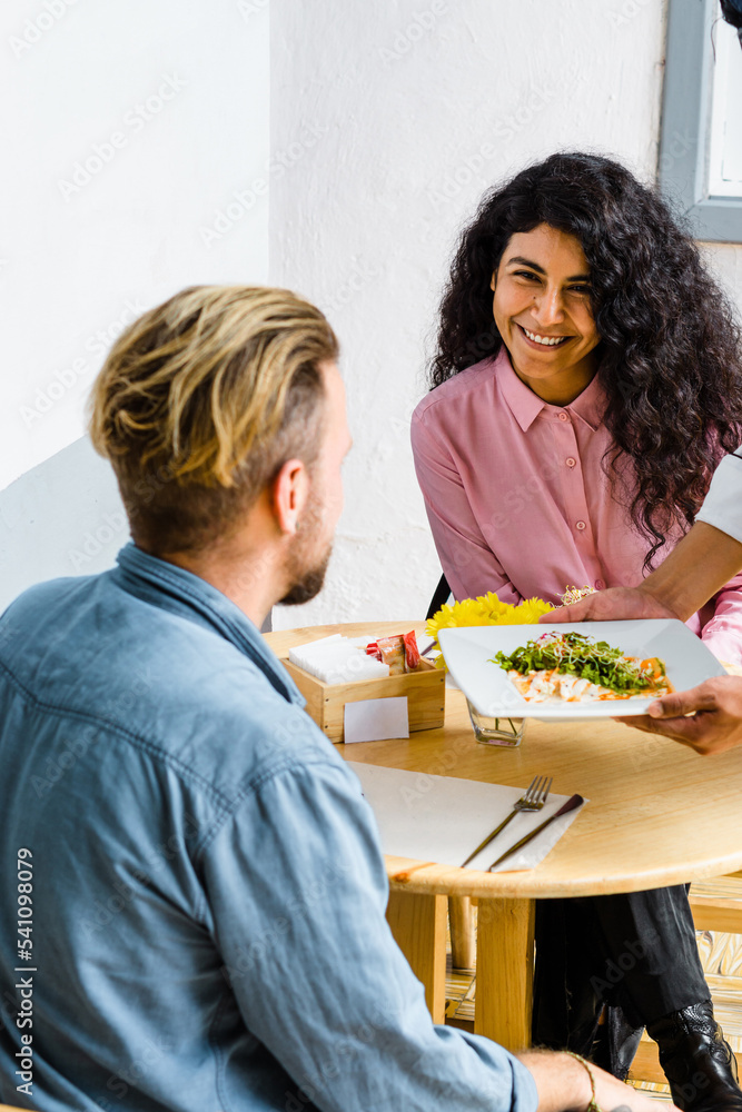 Young and beautiful woman smiling, sitting in the chair in a restaurant. Young and beautiful woman smiling, sitting in the chair in a restaurant.