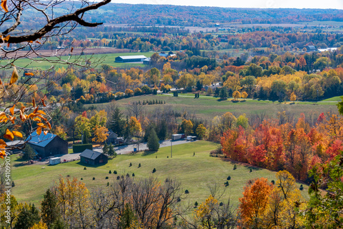 A country home is nestled amongst the Autumn colours as seen from Rattlesnake Point Conservation Area near Milton, Ontario.