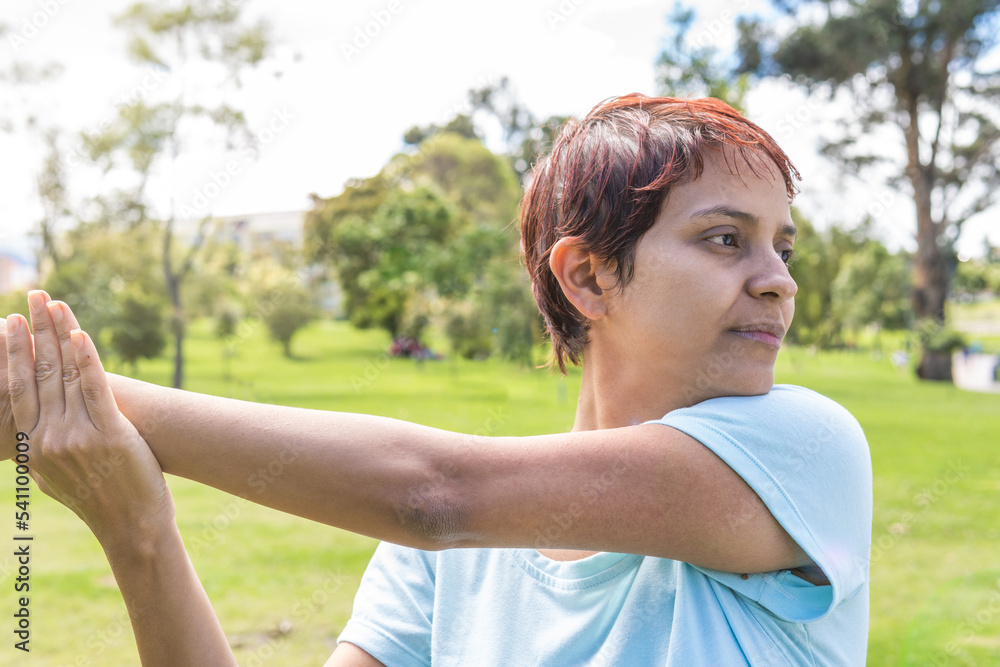 non-binary person stretching and exercising in the park non-binary person stretching and exercising in the park