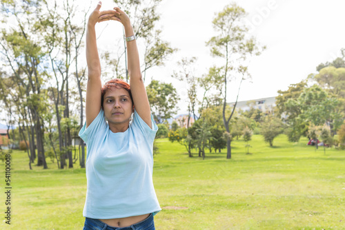 non-binary person stretching for exercise in the park