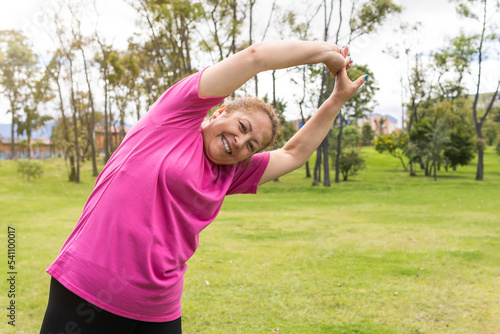 senior woman stretching for exercise in the park