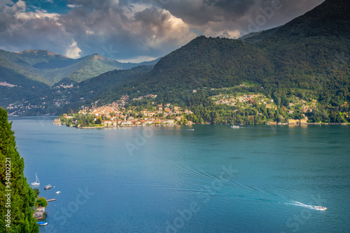 Obraz na płótnie Idyllic Lake Como coastline with village and sailboat at dramatic sunset, Italy w salonie