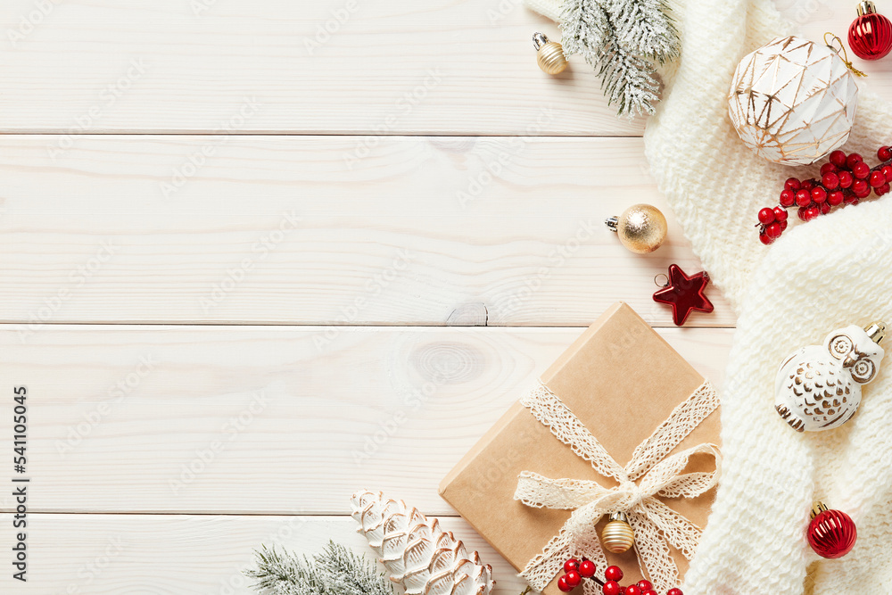 Cozy hygge wooden desk table with Christmas decorations, gift box, fir branches, knitted plaid. Flat lay, top view, copy space Cozy hygge wooden desk table with Christmas decorations, gift box, fir branches, knitted plaid. Flat lay, top view, copy space