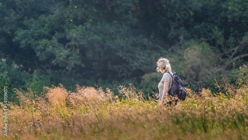 woman walking through a meadow