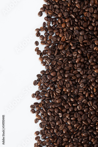 Roasted coffee beans on white surface. Natural food background..