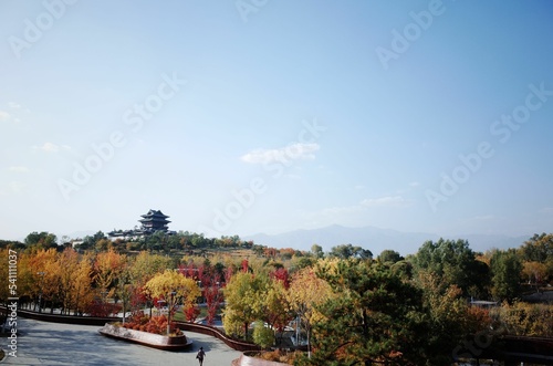 Beautiful royal landscape Jingshan park with a traditional building and autumn trees photo